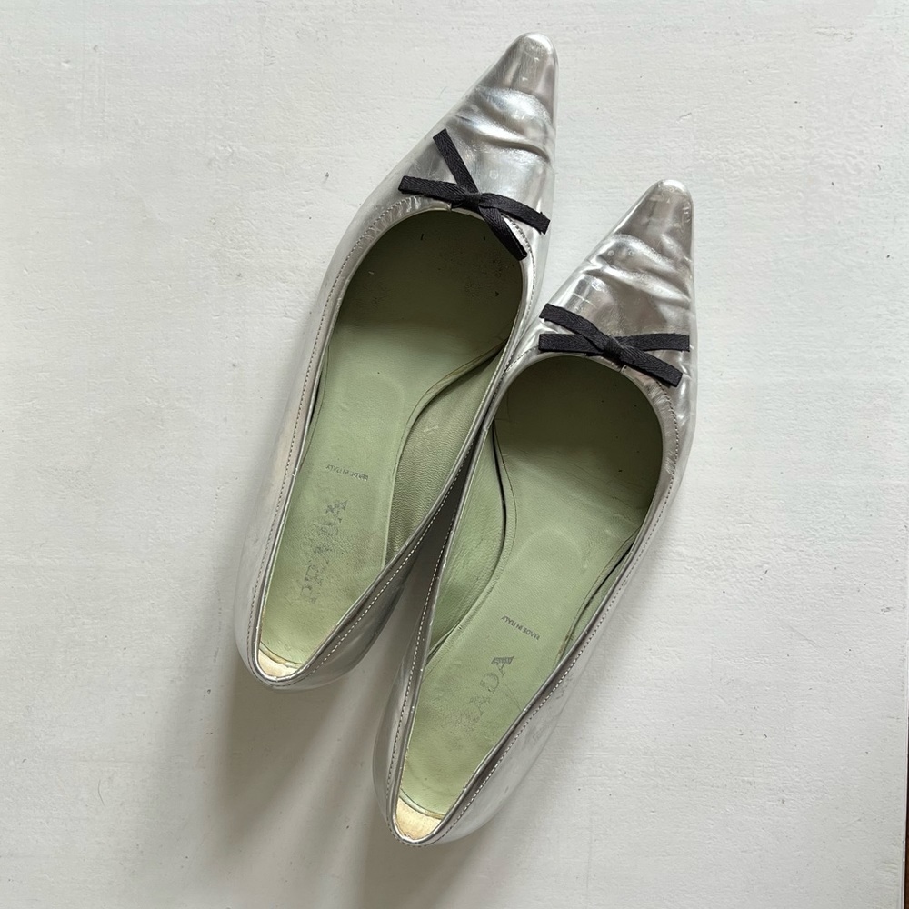 Prada silver mirrored leather pointed toe flats with bow.  Size 7.